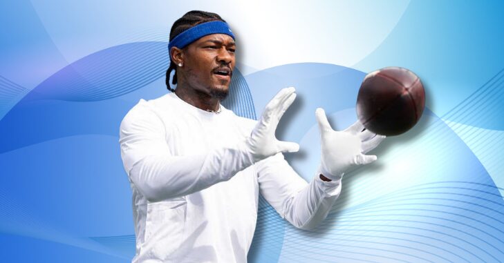 Football player running downfield with the ball