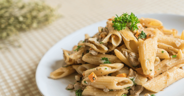 Family style pasta dish set on a dinner table